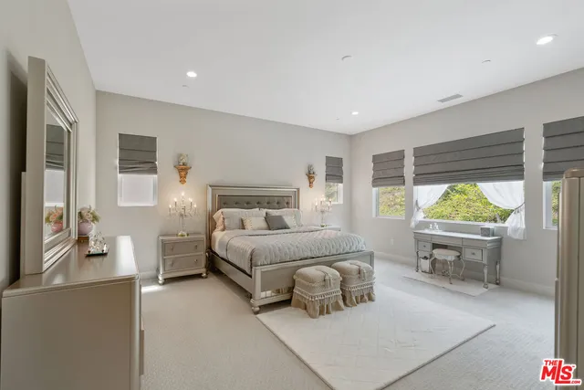 a bedroom with a bed and a large window