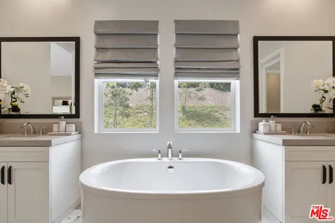 a white bath tub sitting next to a white sink