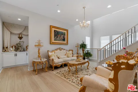 a living room with furniture a rug and a chandelier