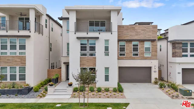 a front view of a house with yard and parking