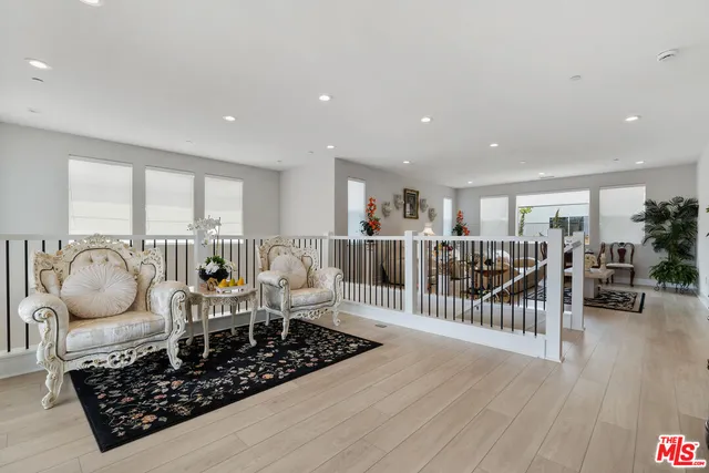 a living room with lots of furniture and a wooden floor