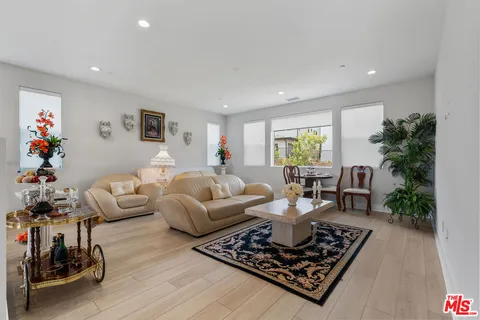 a living room with furniture and a potted plant