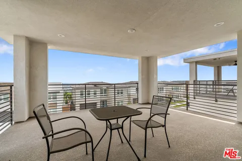 a view of a chairs and table in patio