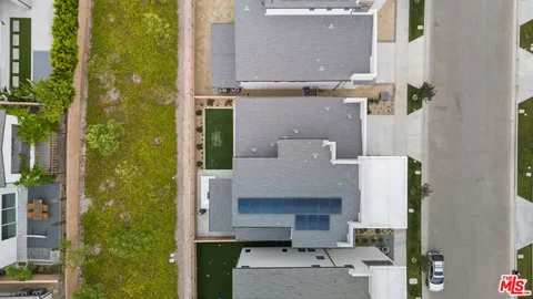 an aerial view of a house with a yard