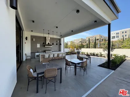 a dining room with furniture and a floor to ceiling window