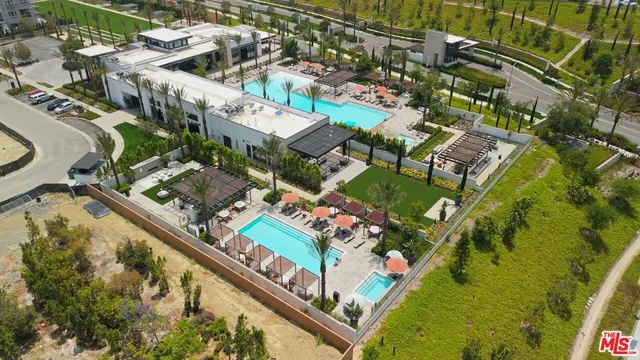 an aerial view of a residential houses with outdoor space
