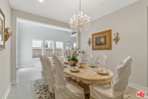 a view of a dining room with furniture wooden floor and chandelier
