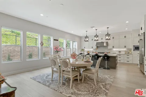 a view of a dining room with furniture and a floor to ceiling window