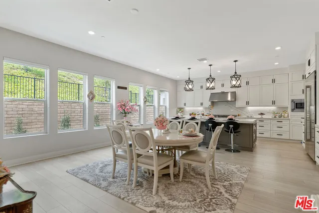 a view of a dining room with furniture and a floor to ceiling window