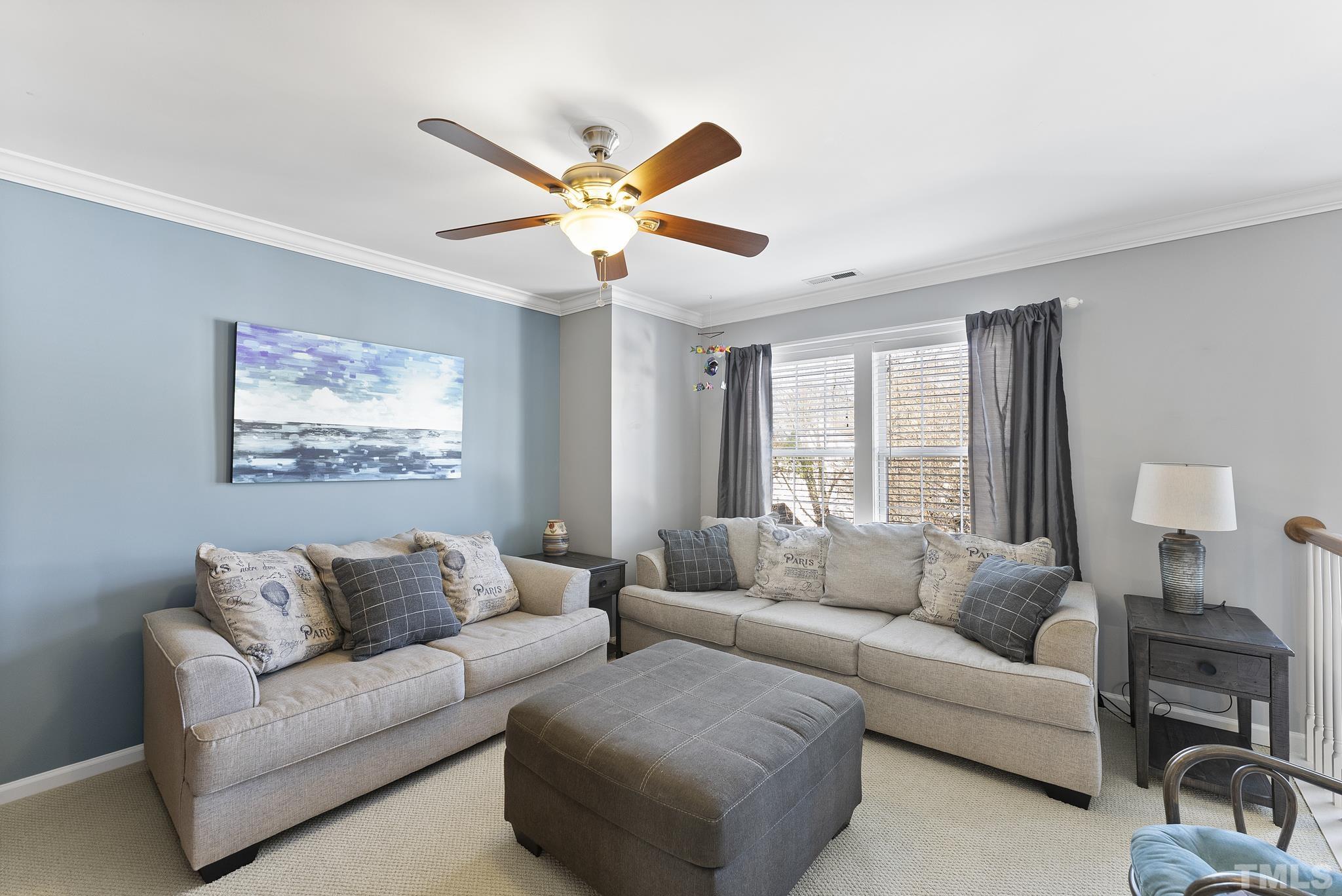 5016 Village Lawn Drive Raleigh, NC 27613 - Photo 15 of 27 a living room with furniture and a large window