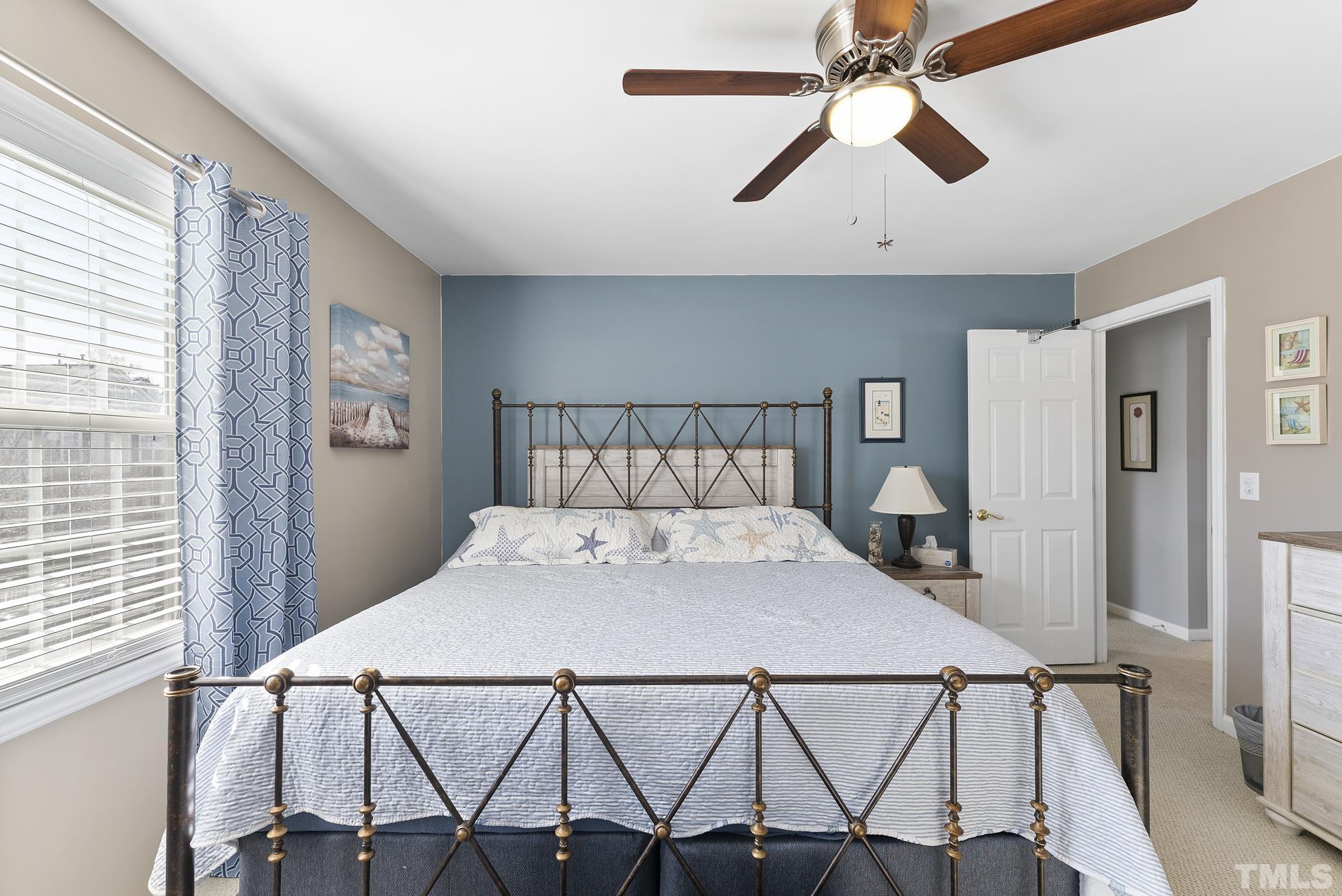 5016 Village Lawn Drive Raleigh, NC 27613 - Photo 17 of 27 a bedroom with a bed and a chandelier