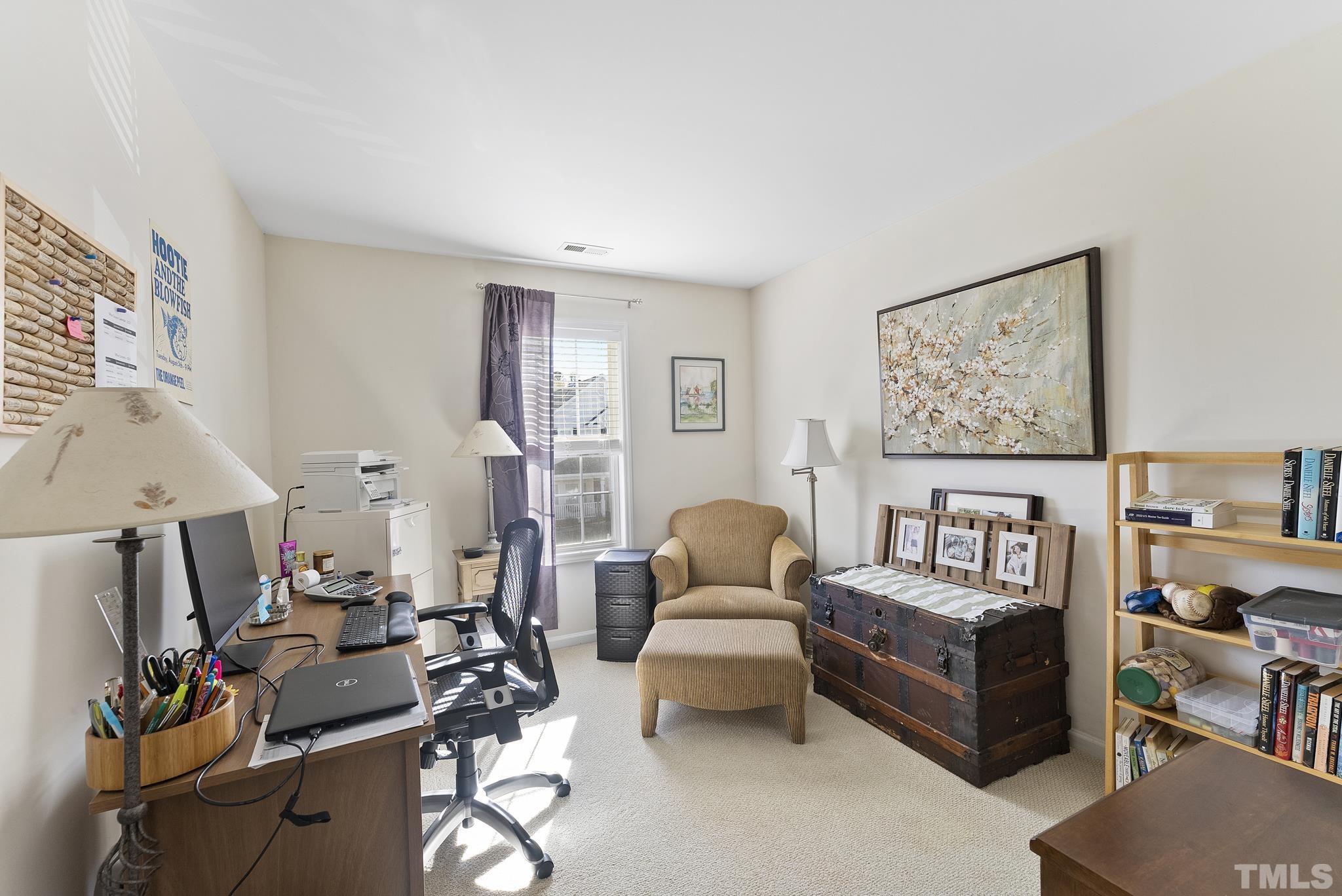 5016 Village Lawn Drive Raleigh, NC 27613 - Photo 18 of 27 a living room with furniture and a flat screen tv