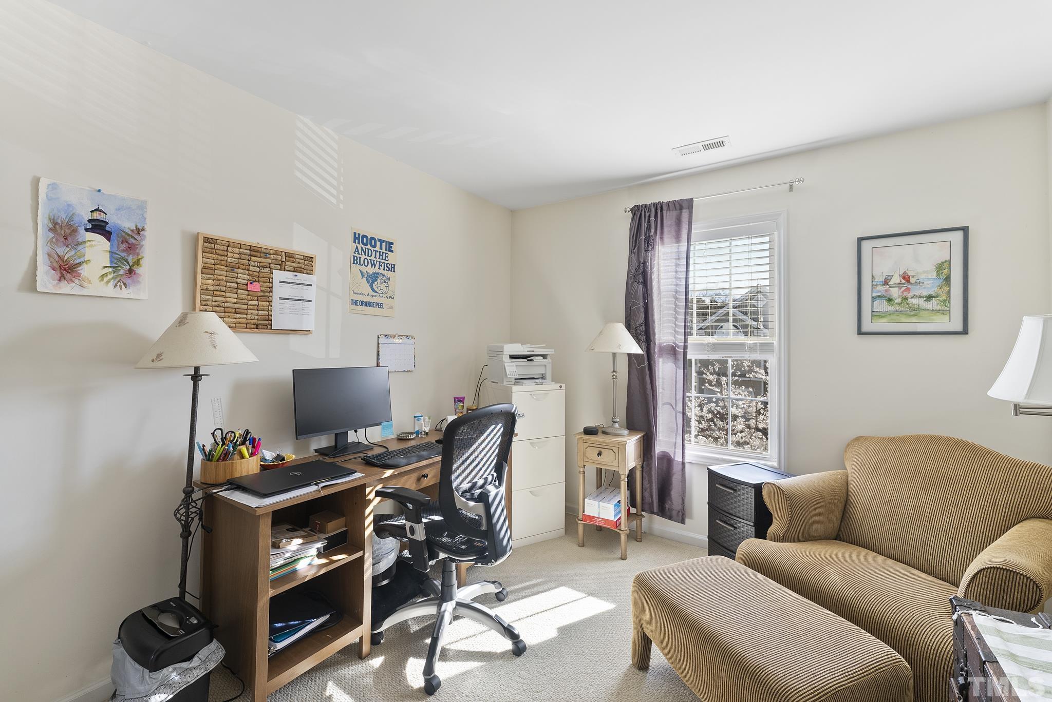 5016 Village Lawn Drive Raleigh, NC 27613 - Photo 19 of 27 a view of a livingroom with workspace and a couch