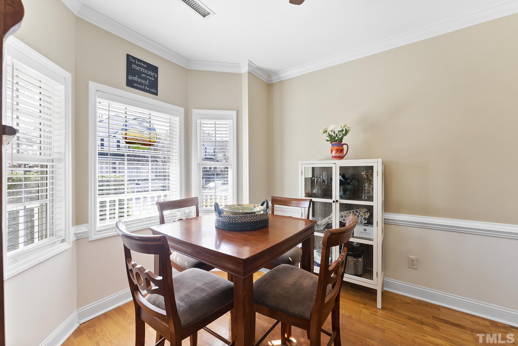 5016 Village Lawn Drive Raleigh, NC 27613 - Photo 4 of 27 a dining room with furniture and wooden floor