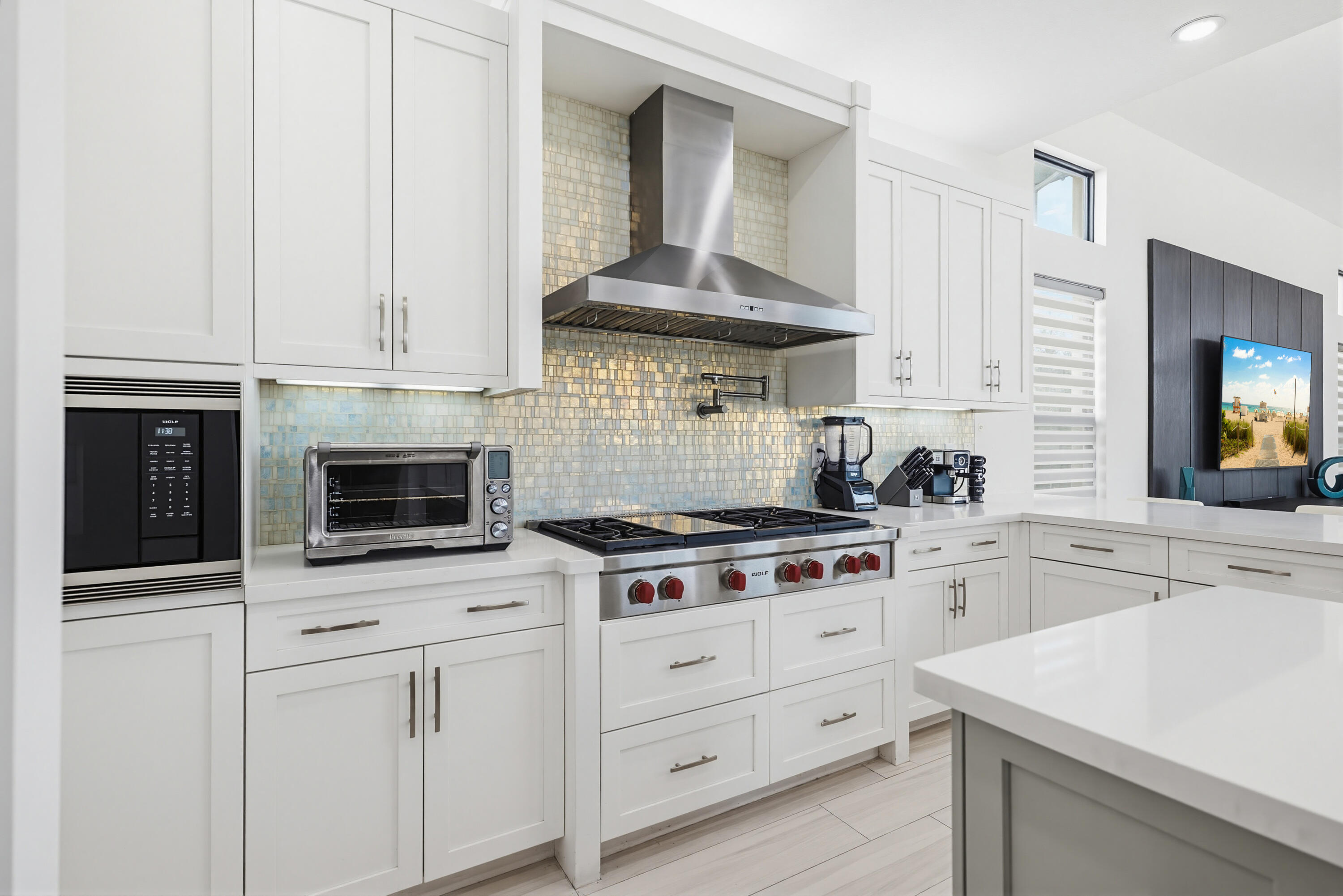 9801 Rennes Lane Delray Beach, FL 33446 - Photo 14 of 77 a kitchen with white cabinets and appliances