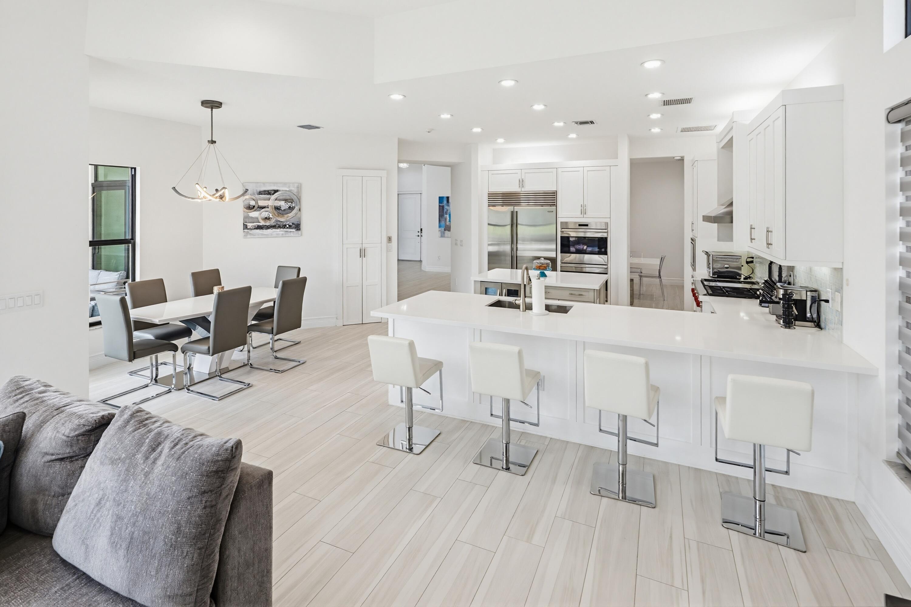 9801 Rennes Lane Delray Beach, FL 33446 - Photo 15 of 77 a kitchen with stainless steel appliances kitchen island granite countertop a sink and cabinets