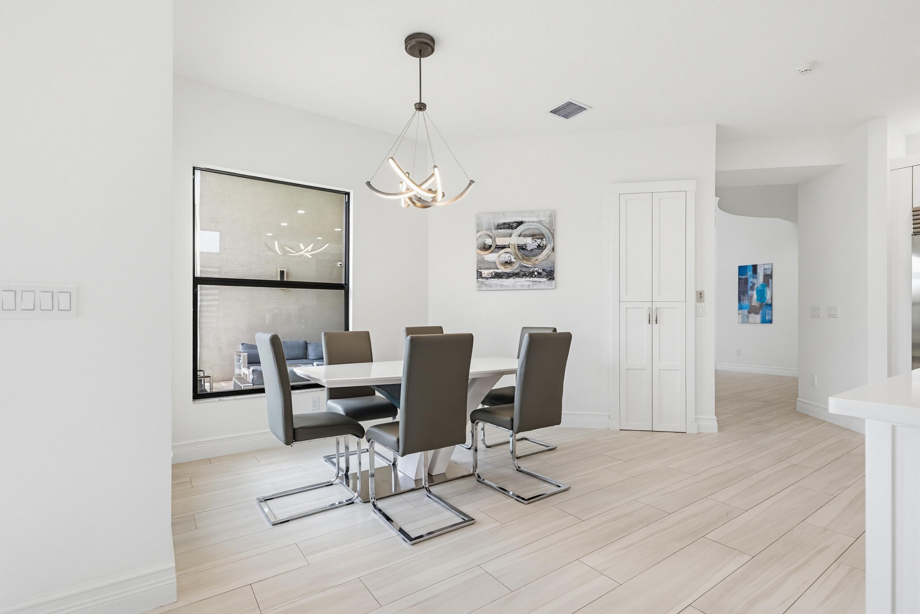9801 Rennes Lane Delray Beach, FL 33446 - Photo 17 of 77 a view of a livingroom with furniture and wooden floor