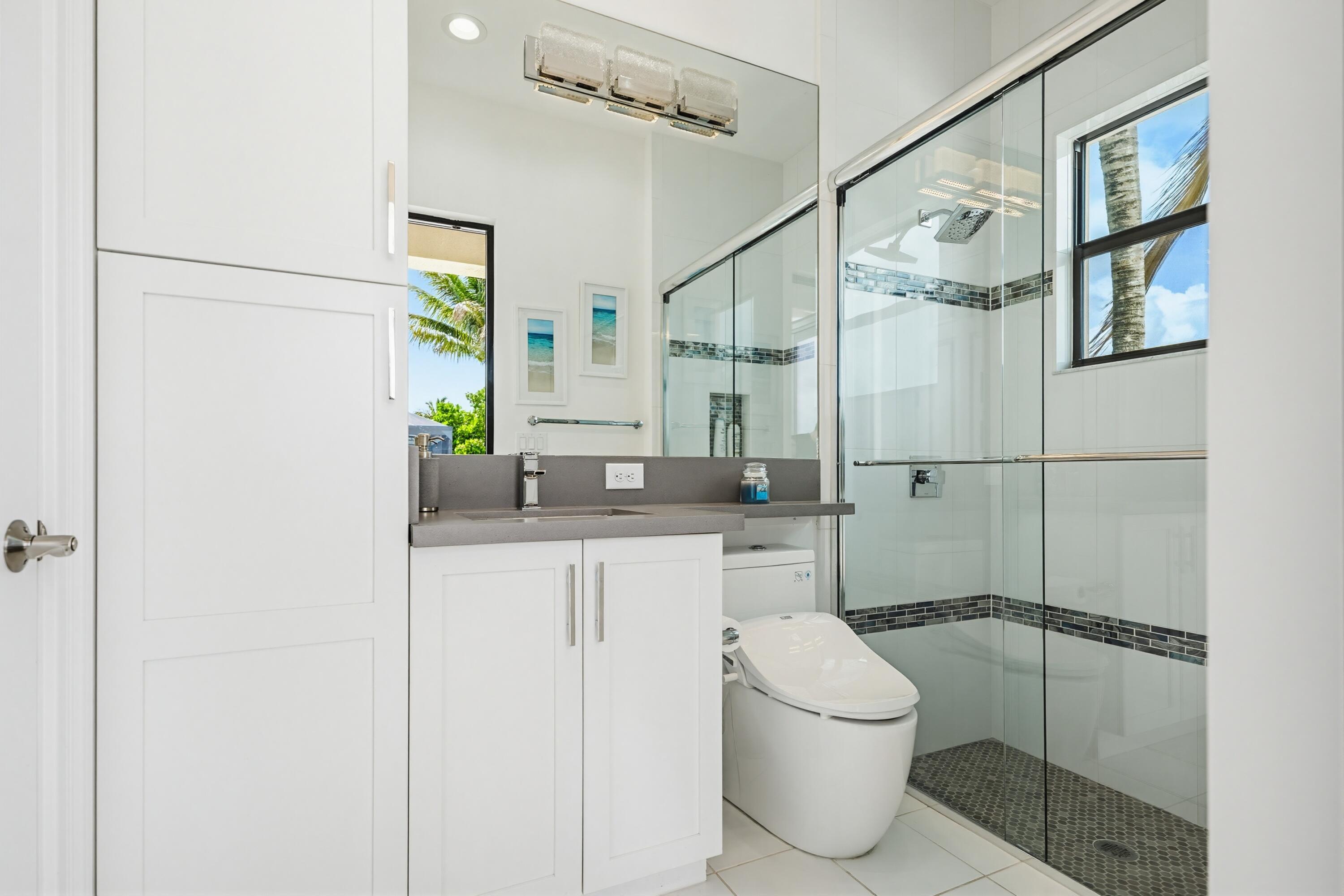 9801 Rennes Lane Delray Beach, FL 33446 - Photo 21 of 77 a bathroom with a granite countertop sink a toilet and shower