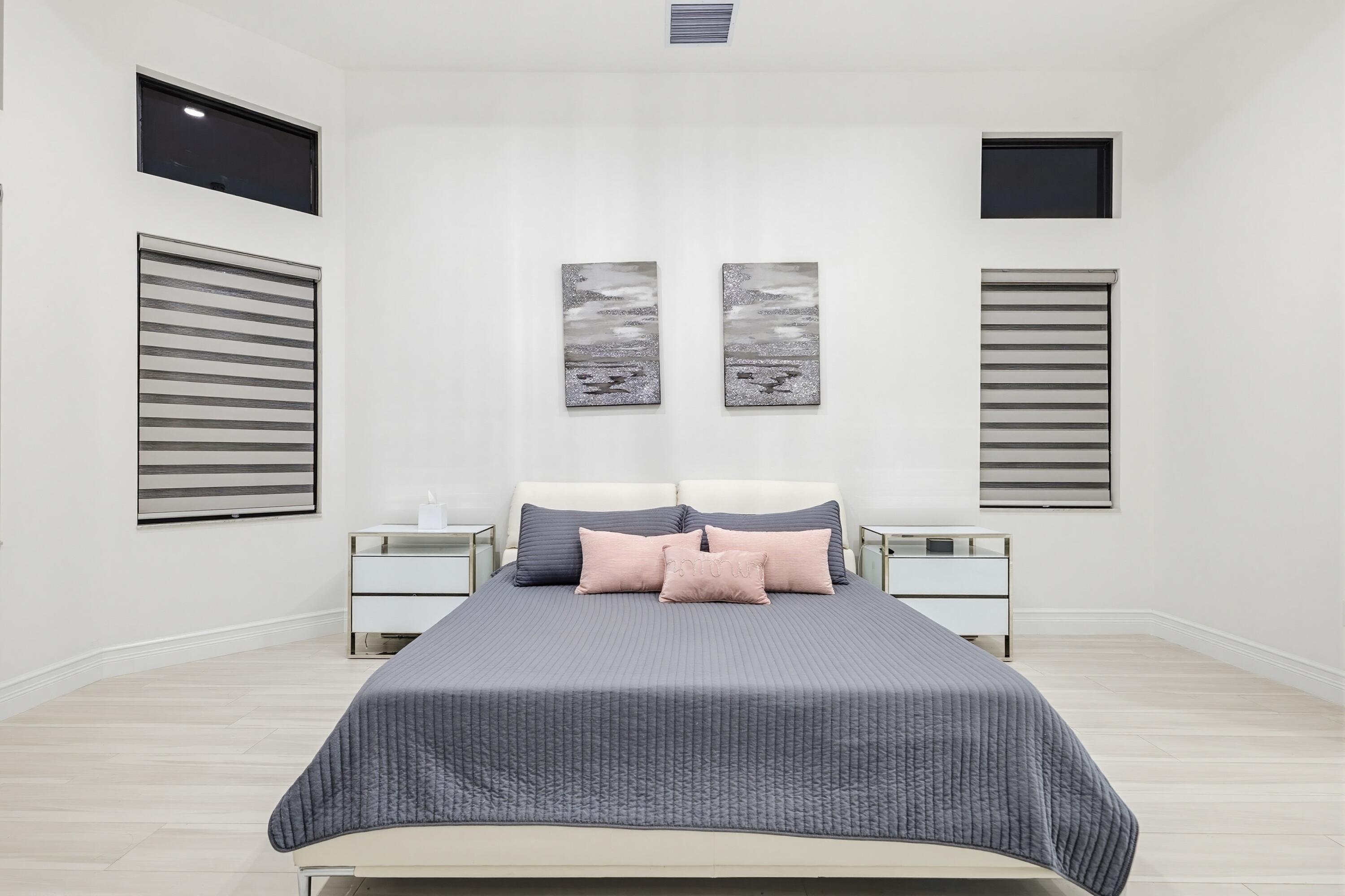 9801 Rennes Lane Delray Beach, FL 33446 - Photo 27 of 77 a bedroom with a bed and a flat screen tv