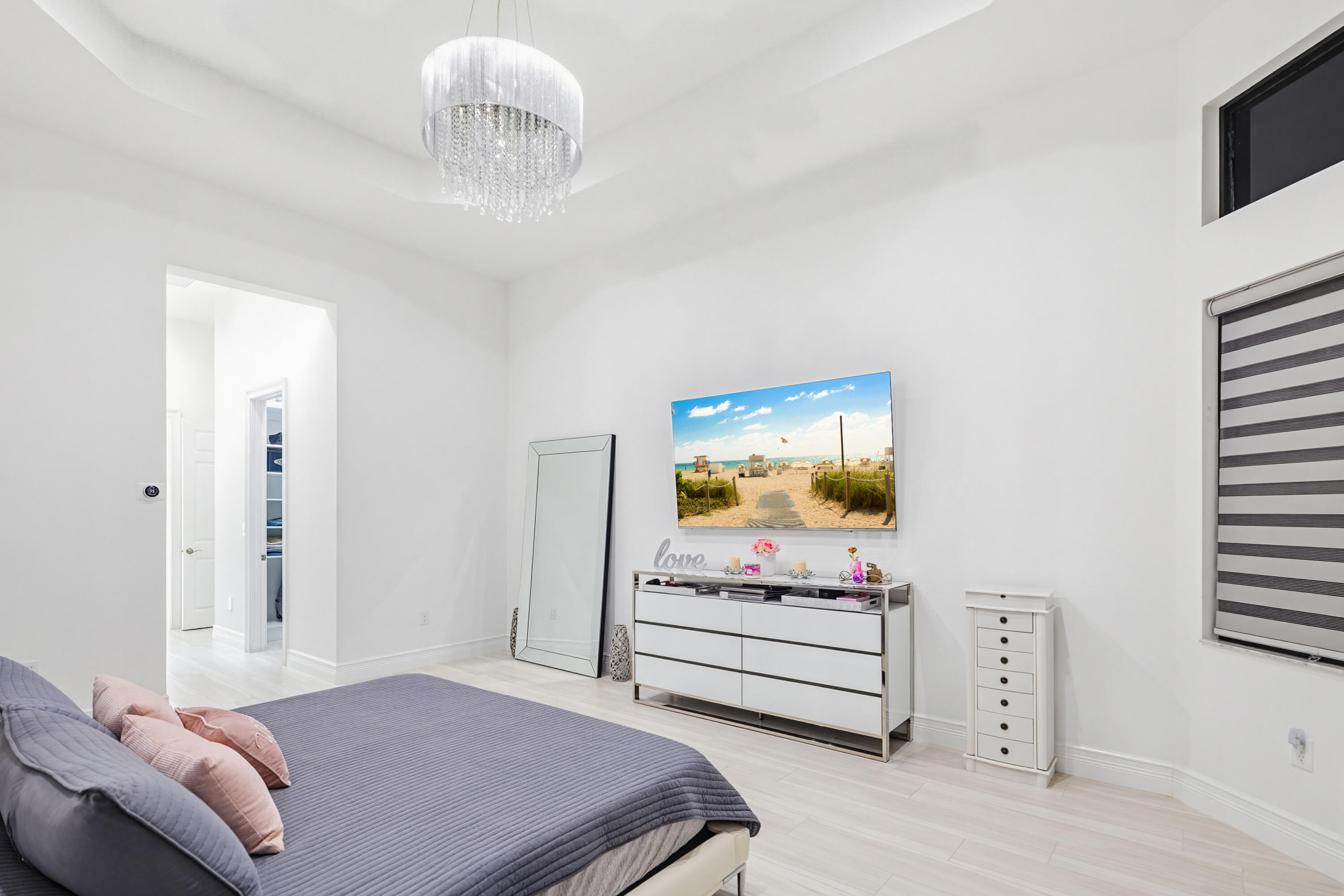 9801 Rennes Lane Delray Beach, FL 33446 - Photo 28 of 77 a bedroom with furniture and a flat screen tv