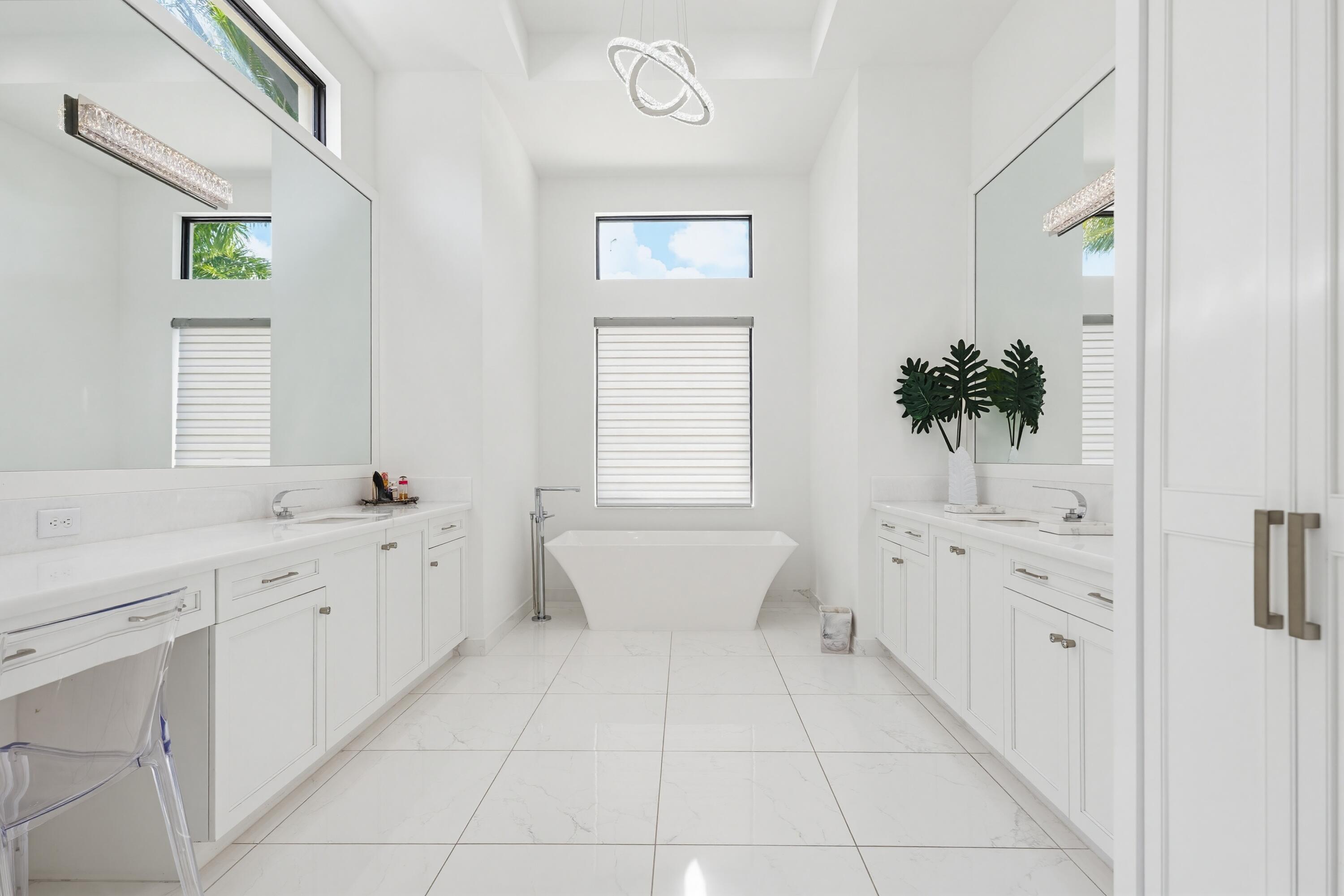 9801 Rennes Lane Delray Beach, FL 33446 - Photo 30 of 77 a bathroom with a bathtub sink and mirror