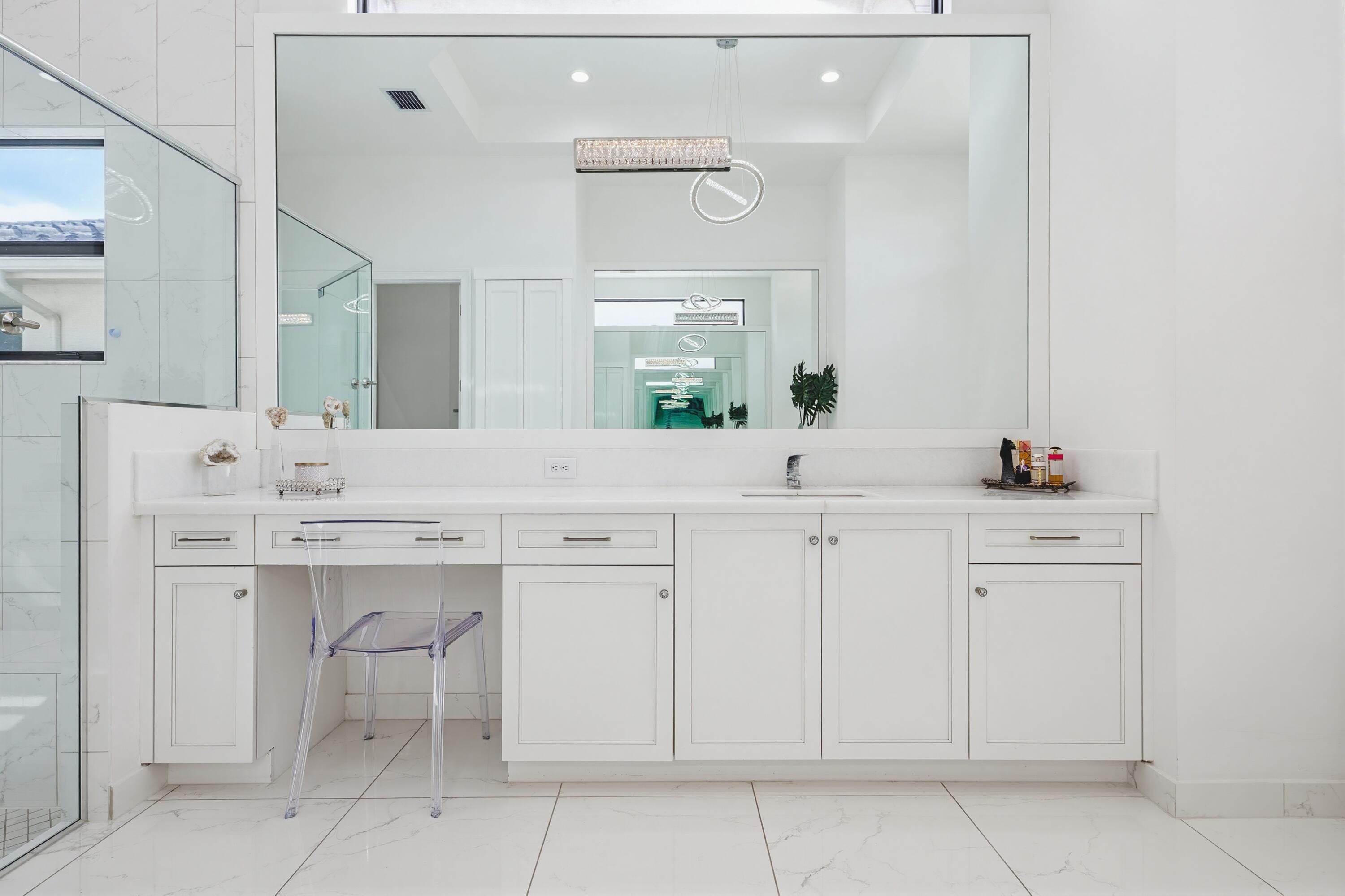 9801 Rennes Lane Delray Beach, FL 33446 - Photo 34 of 77 a bathroom with a sink and a mirror