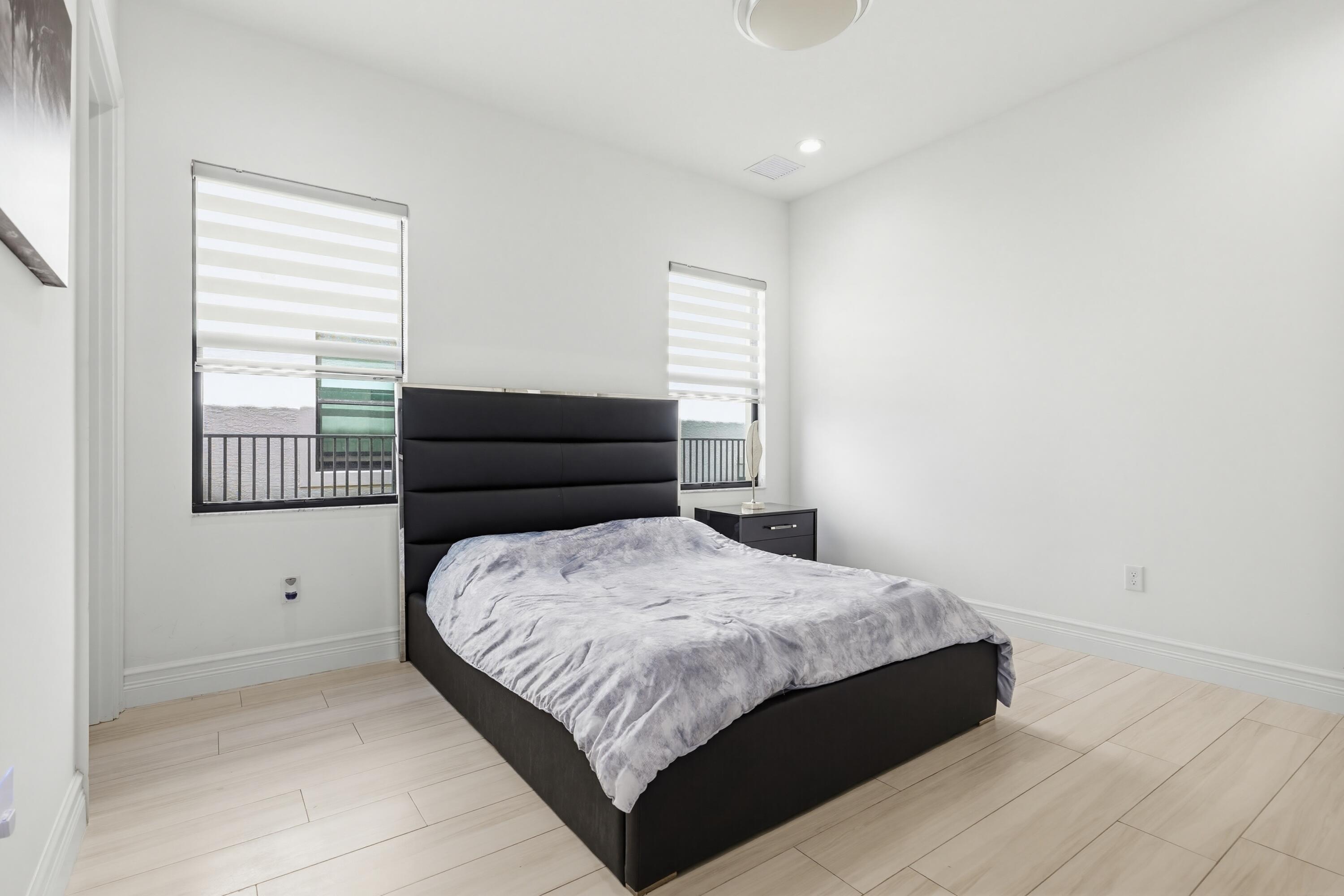 9801 Rennes Lane Delray Beach, FL 33446 - Photo 37 of 77 a bedroom with a bed and window