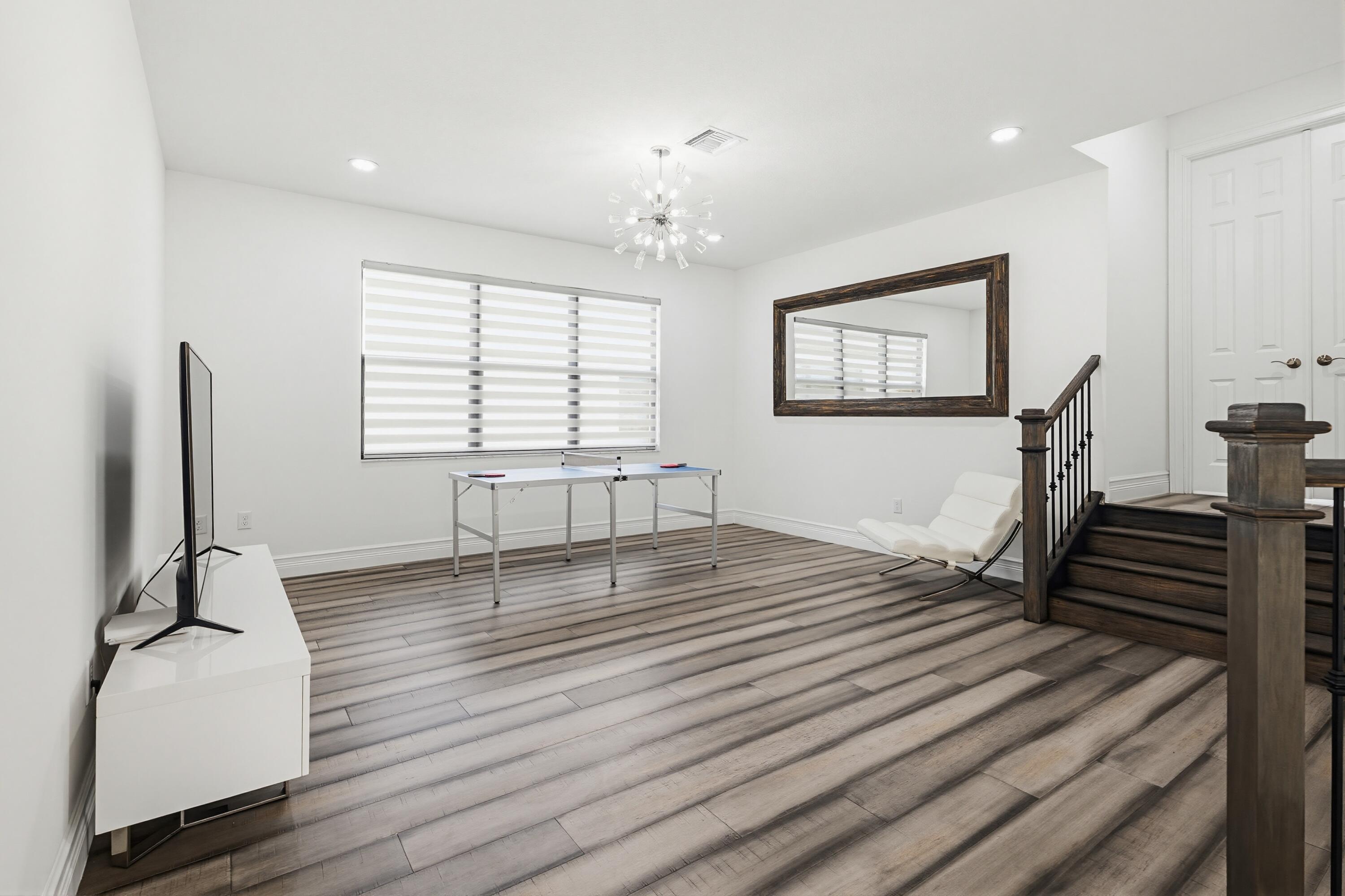 9801 Rennes Lane Delray Beach, FL 33446 - Photo 40 of 77 a view of an empty room with wooden floor and a window