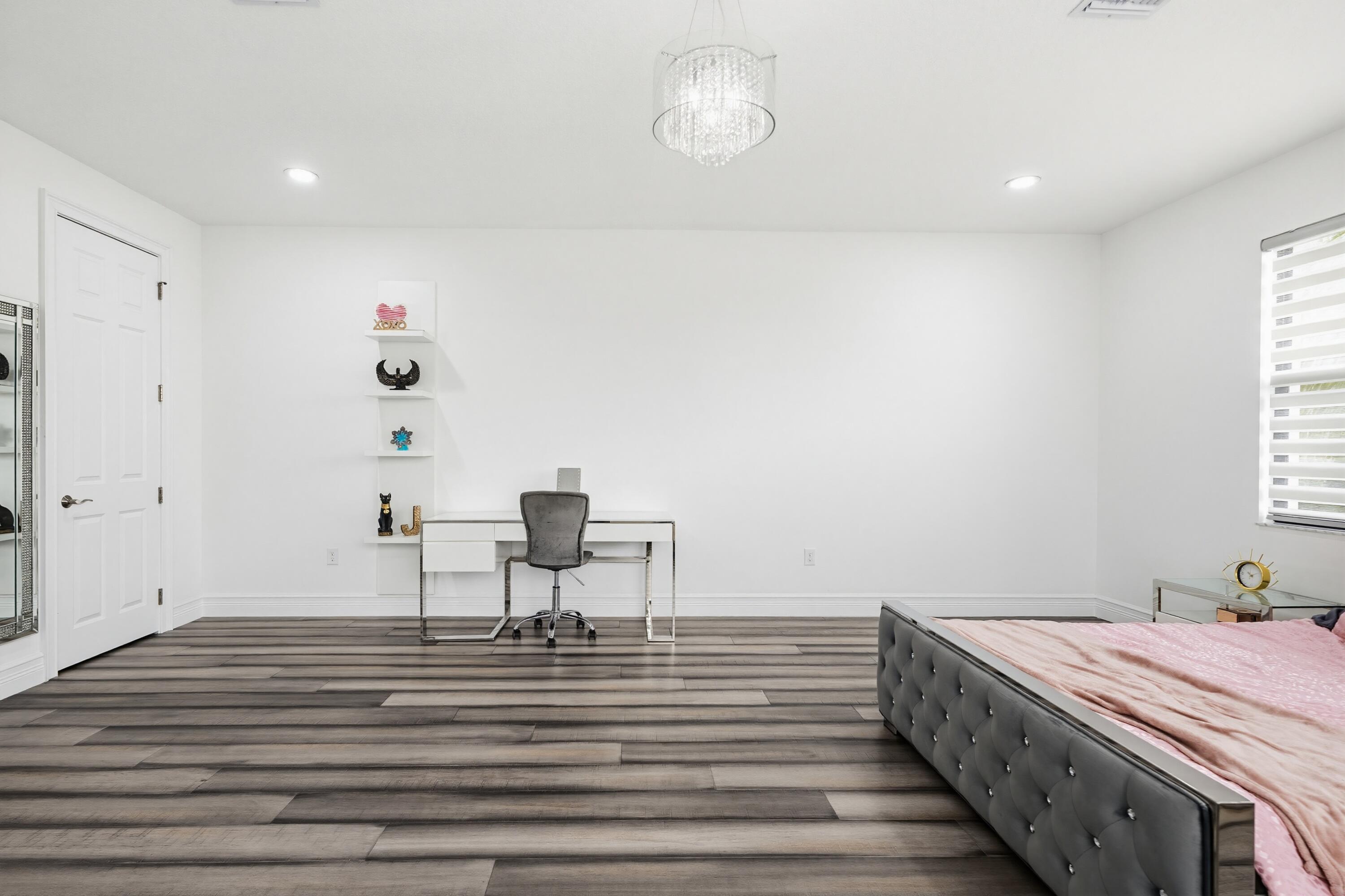 9801 Rennes Lane Delray Beach, FL 33446 - Photo 43 of 77 a view of a room with wooden floor and chair