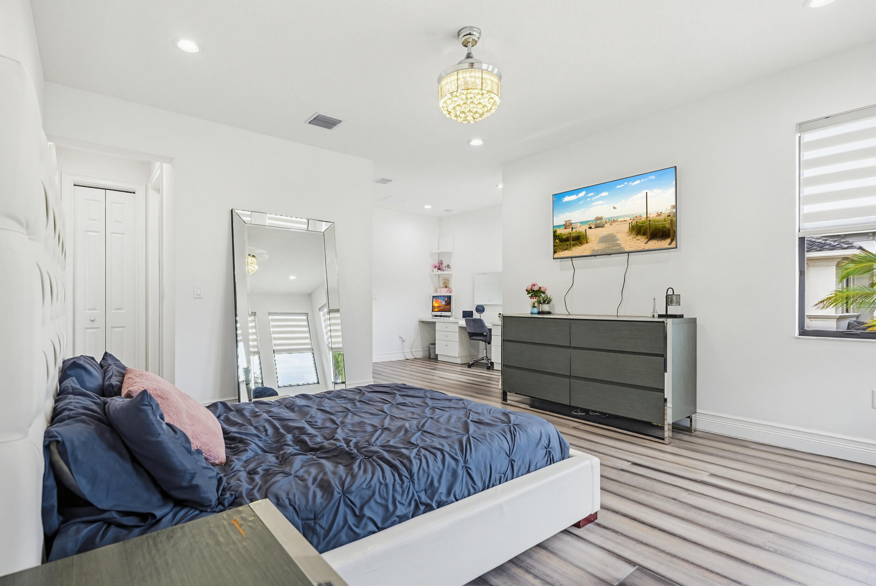 9801 Rennes Lane Delray Beach, FL 33446 - Photo 54 of 77 a bedroom with a bed and painting on the wall