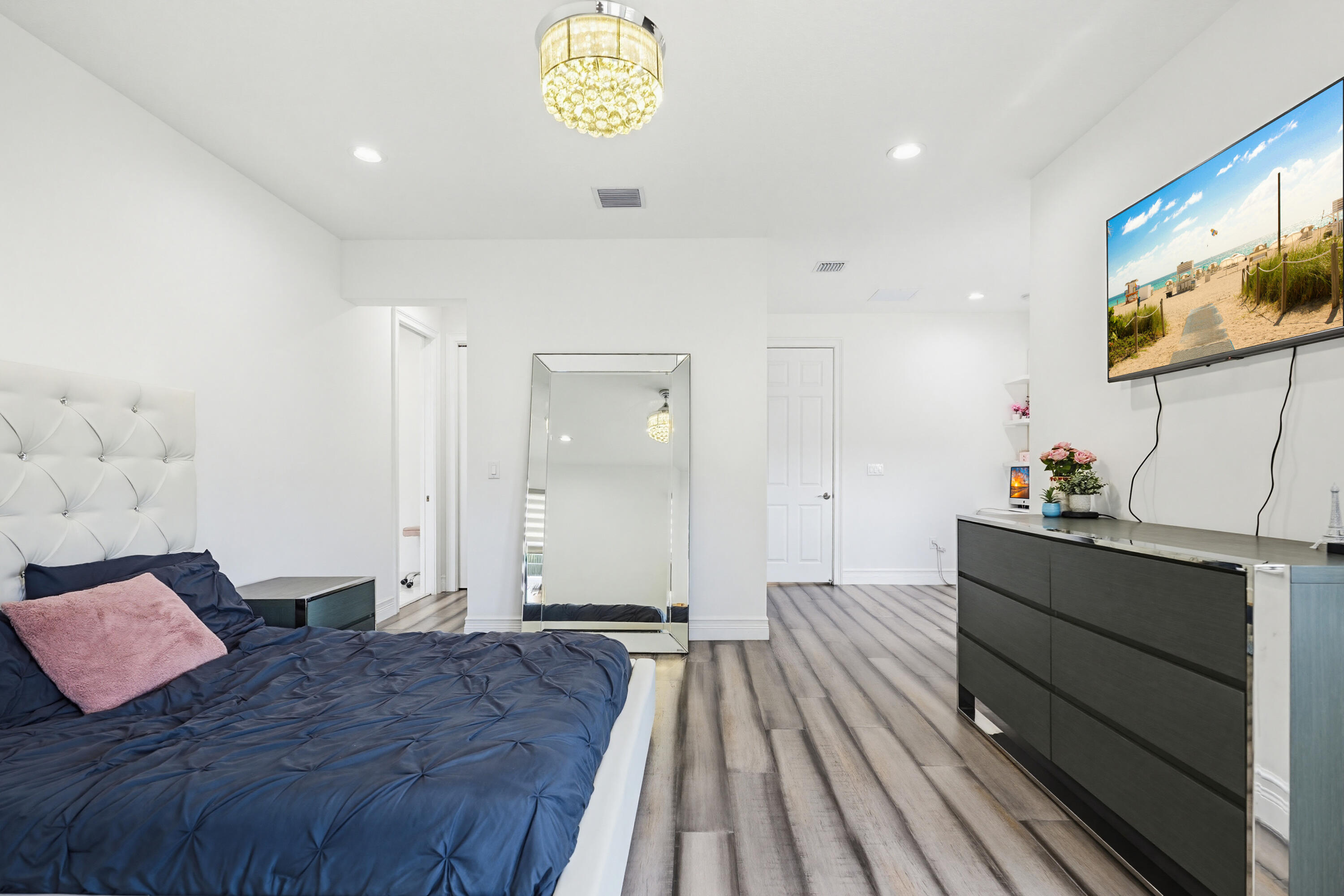 9801 Rennes Lane Delray Beach, FL 33446 - Photo 55 of 77 a spacious bedroom with a bed and a desk