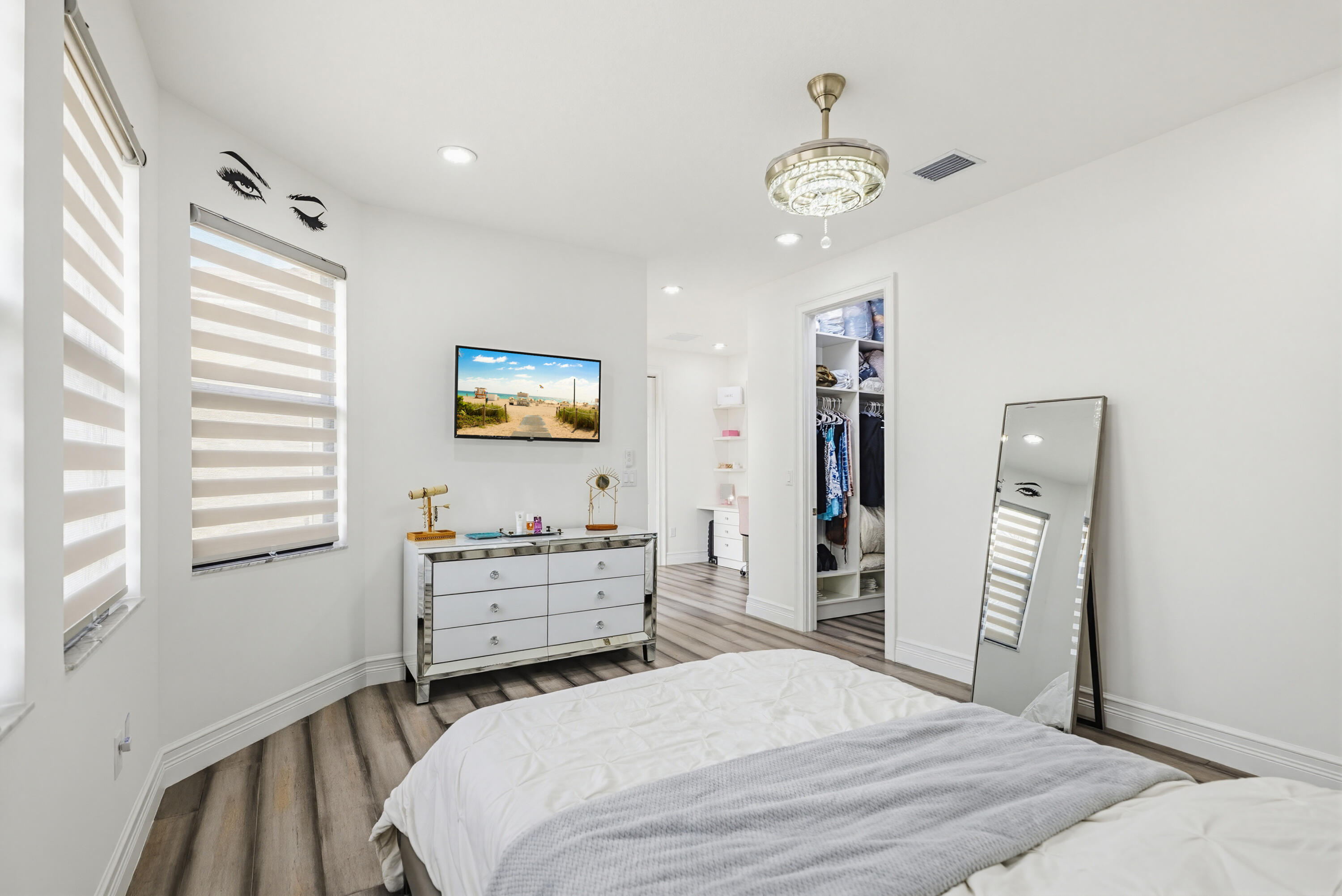 9801 Rennes Lane Delray Beach, FL 33446 - Photo 58 of 77 a bedroom with a bed and a chandelier