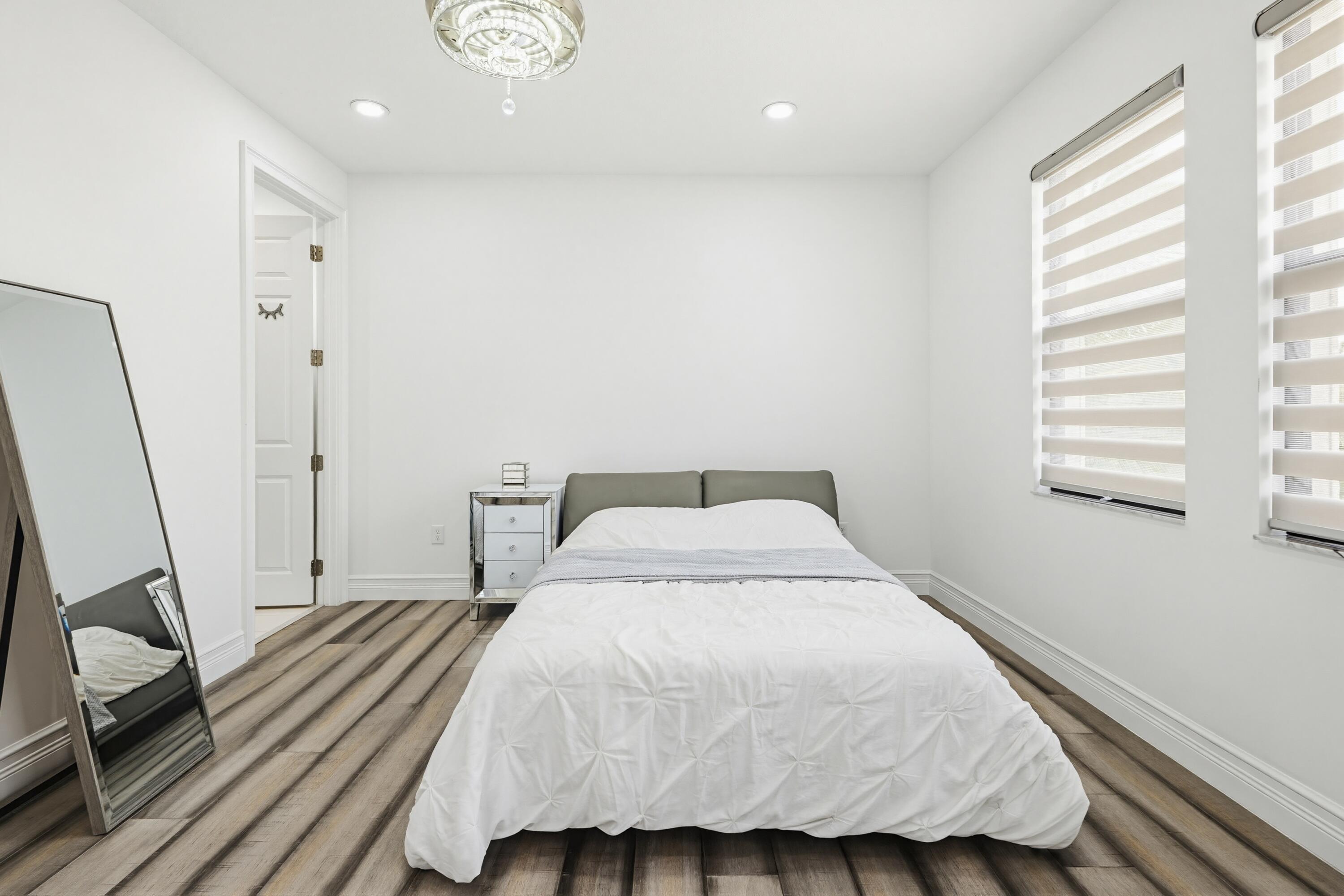 9801 Rennes Lane Delray Beach, FL 33446 - Photo 62 of 77 a bedroom with a bed and a window