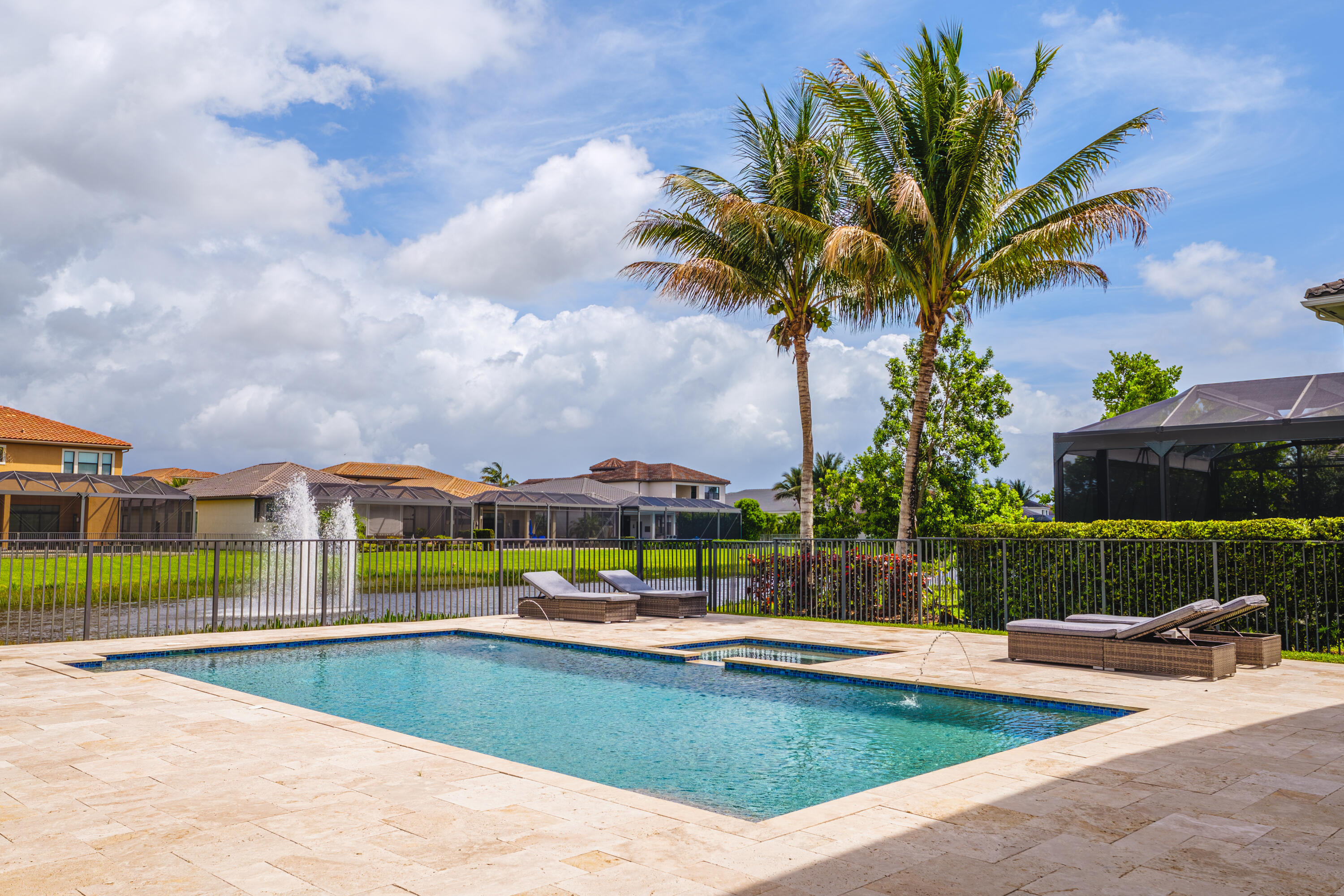 9801 Rennes Lane Delray Beach, FL 33446 - Photo 66 of 77 a view of a swimming pool with a lounge chairs and a yard