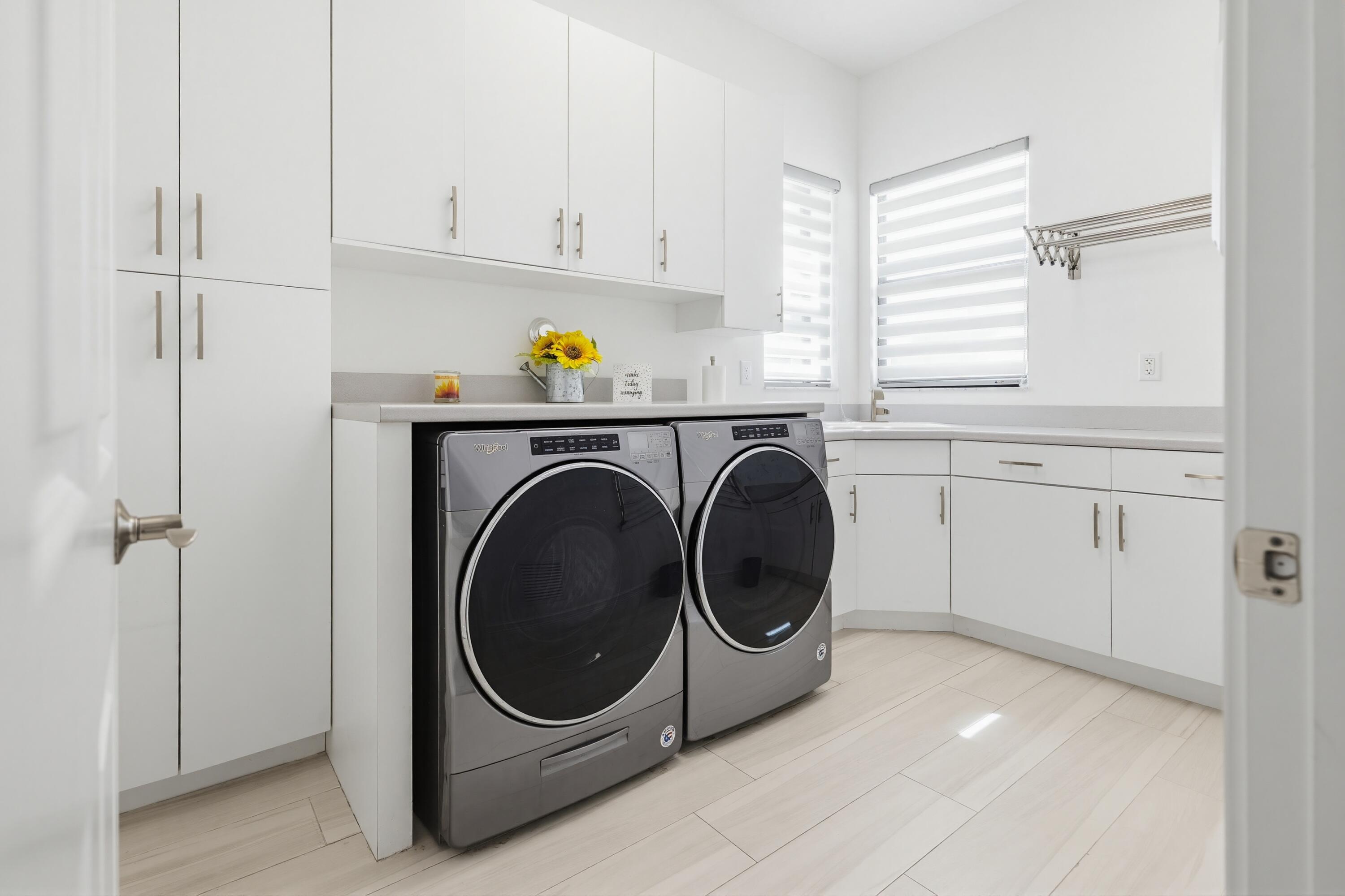 9801 Rennes Lane Delray Beach, FL 33446 - Photo 73 of 77 a utility room with sink dryer and washer