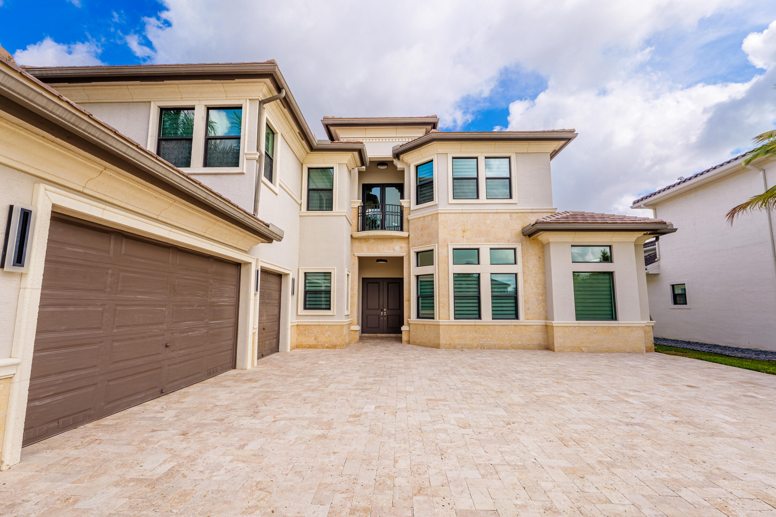 9801 Rennes Lane Delray Beach, FL 33446 - Photo 76 of 77 a front view of a house with glass windows and yard