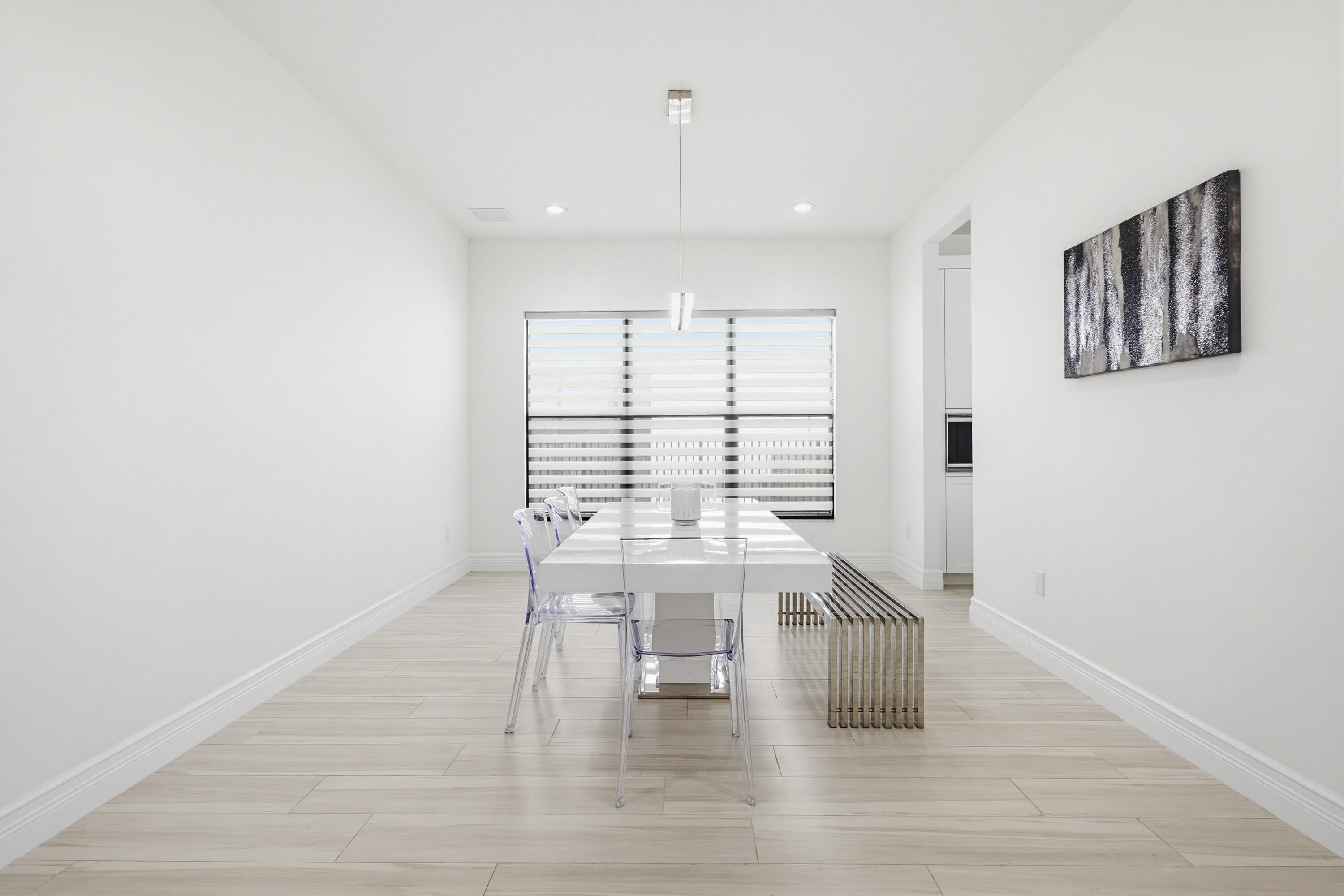 9801 Rennes Lane Delray Beach, FL 33446 - Photo 9 of 77 a view of a livingroom with wooden floor and a window