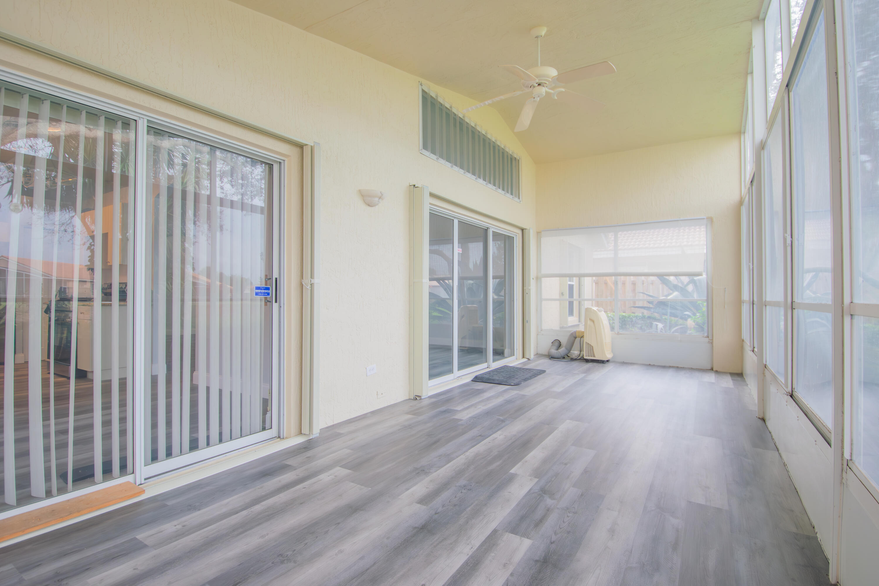 7243 Modena Drive Boynton Beach, FL 33437 - Photo 15 of 28 a view of a big room with wooden floor and windows