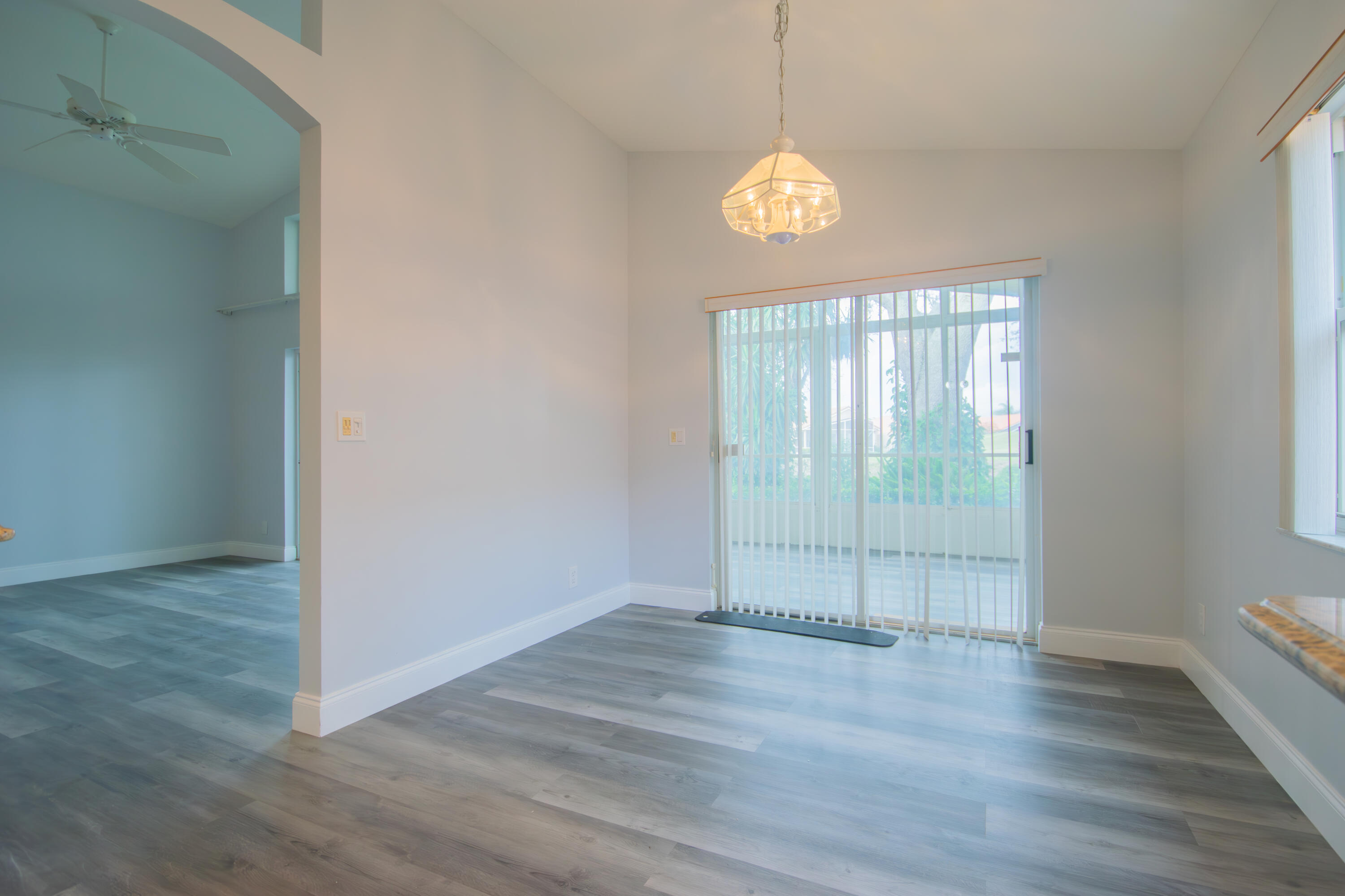 7243 Modena Drive Boynton Beach, FL 33437 - Photo 16 of 28 an empty room with wooden floor and windows