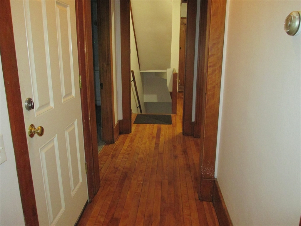 5 Oberlin Street, Unit 2 Worcester, MA 01610 - Photo 15 of 22 a view of a hallway with wooden floor
