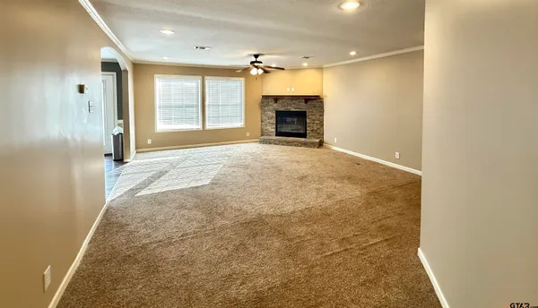 a view of empty room with a fireplace
