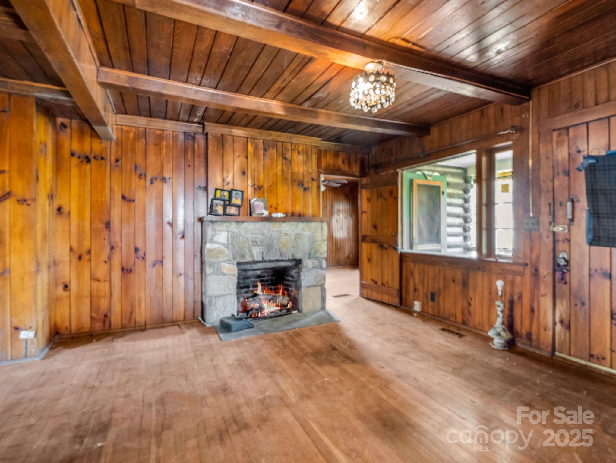 541 Broadway Street Hendersonville, NC 28739 - Photo 15 of 37 a view of an empty room with a fireplace and a window