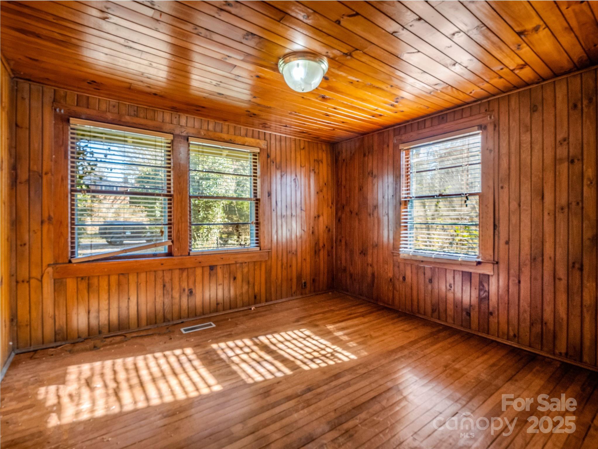 541 Broadway Street Hendersonville, NC 28739 - Photo 32 of 37 an empty room with wooden floor and windows