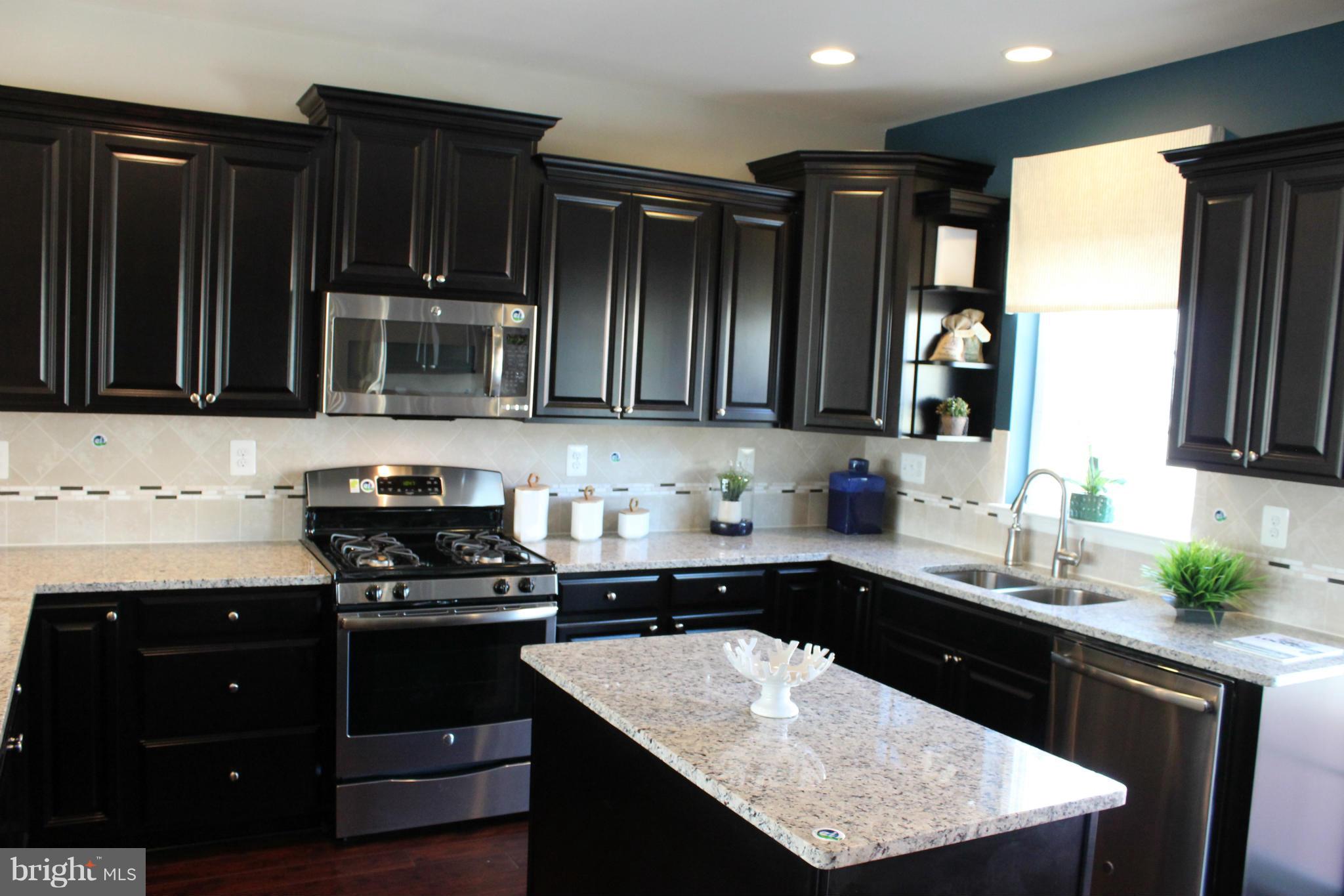 1012 Red Clover Road Gambrills, MD 21054 - Photo 13 of 30 a kitchen with a sink a stove and cabinets