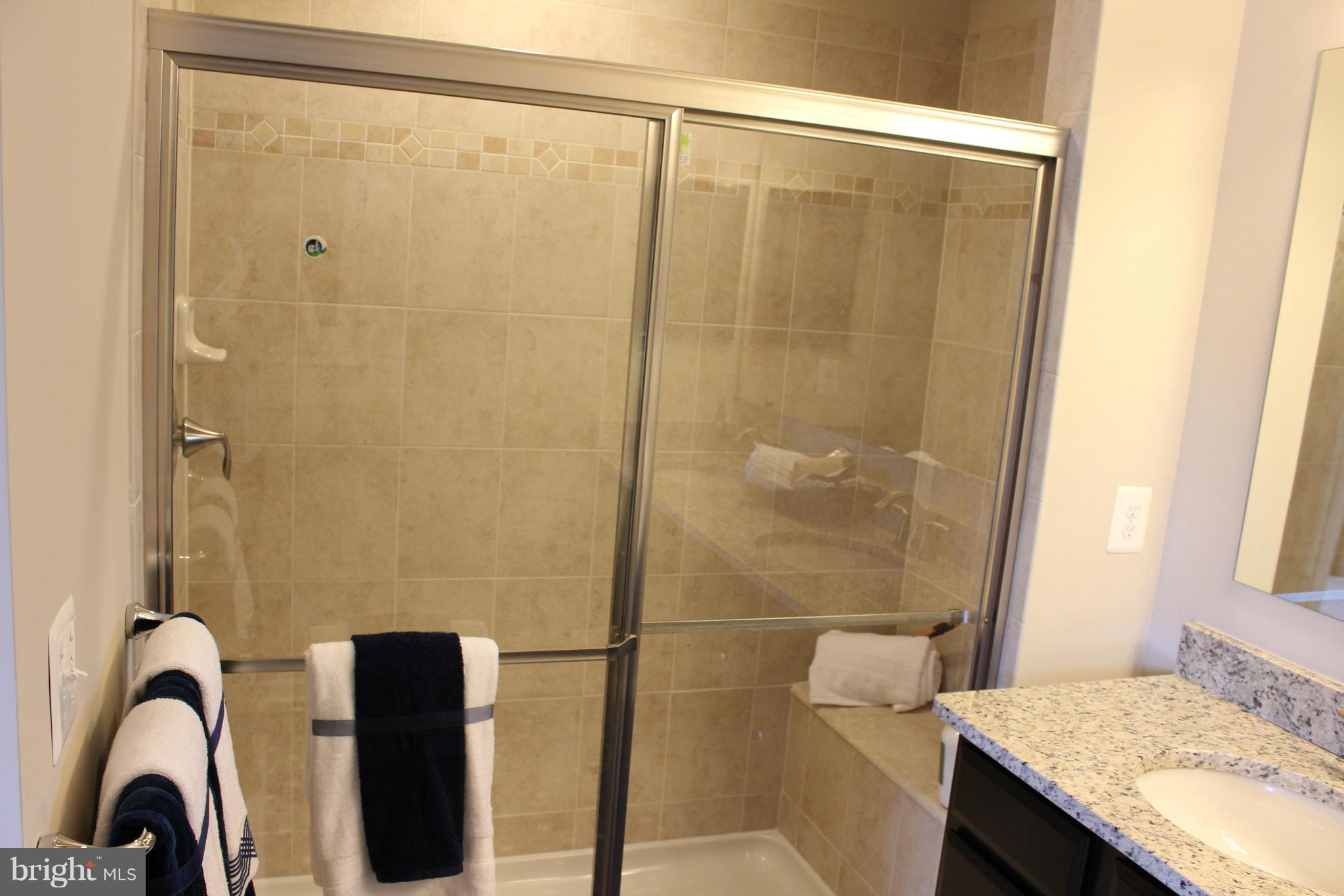 1012 Red Clover Road Gambrills, MD 21054 - Photo 6 of 30 a bathroom with a granite countertop sink and a shower