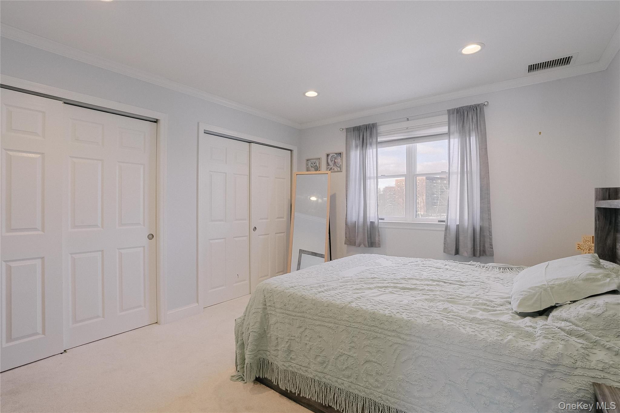 37 Harbor Lane, Unit 2C New Rochelle, NY 10805 - Photo 11 of 17 a spacious bedroom with a bed and a window