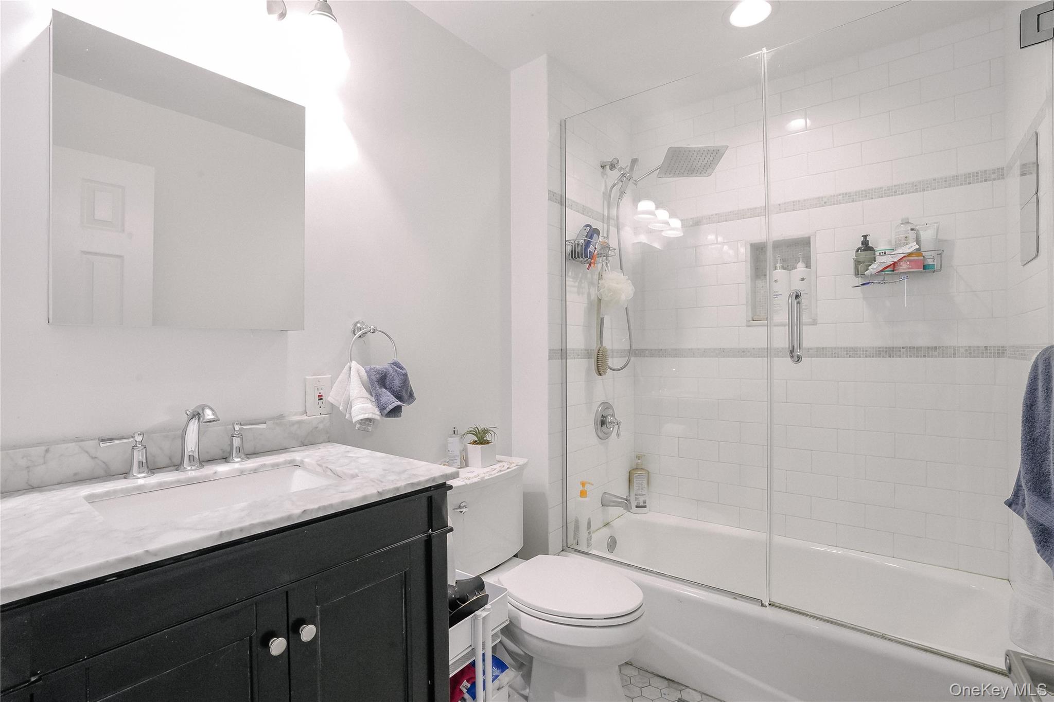 37 Harbor Lane, Unit 2C New Rochelle, NY 10805 - Photo 12 of 17 a bathroom with a sink a toilet and shower