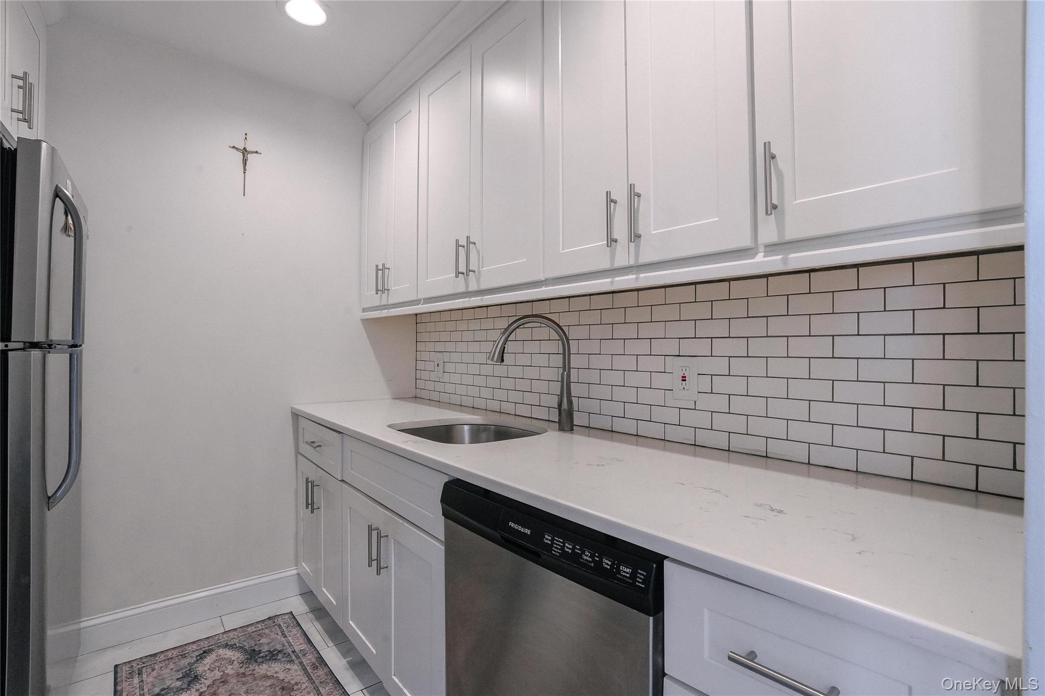 37 Harbor Lane, Unit 2C New Rochelle, NY 10805 - Photo 7 of 17 a view of a kitchen with sink and cabinets