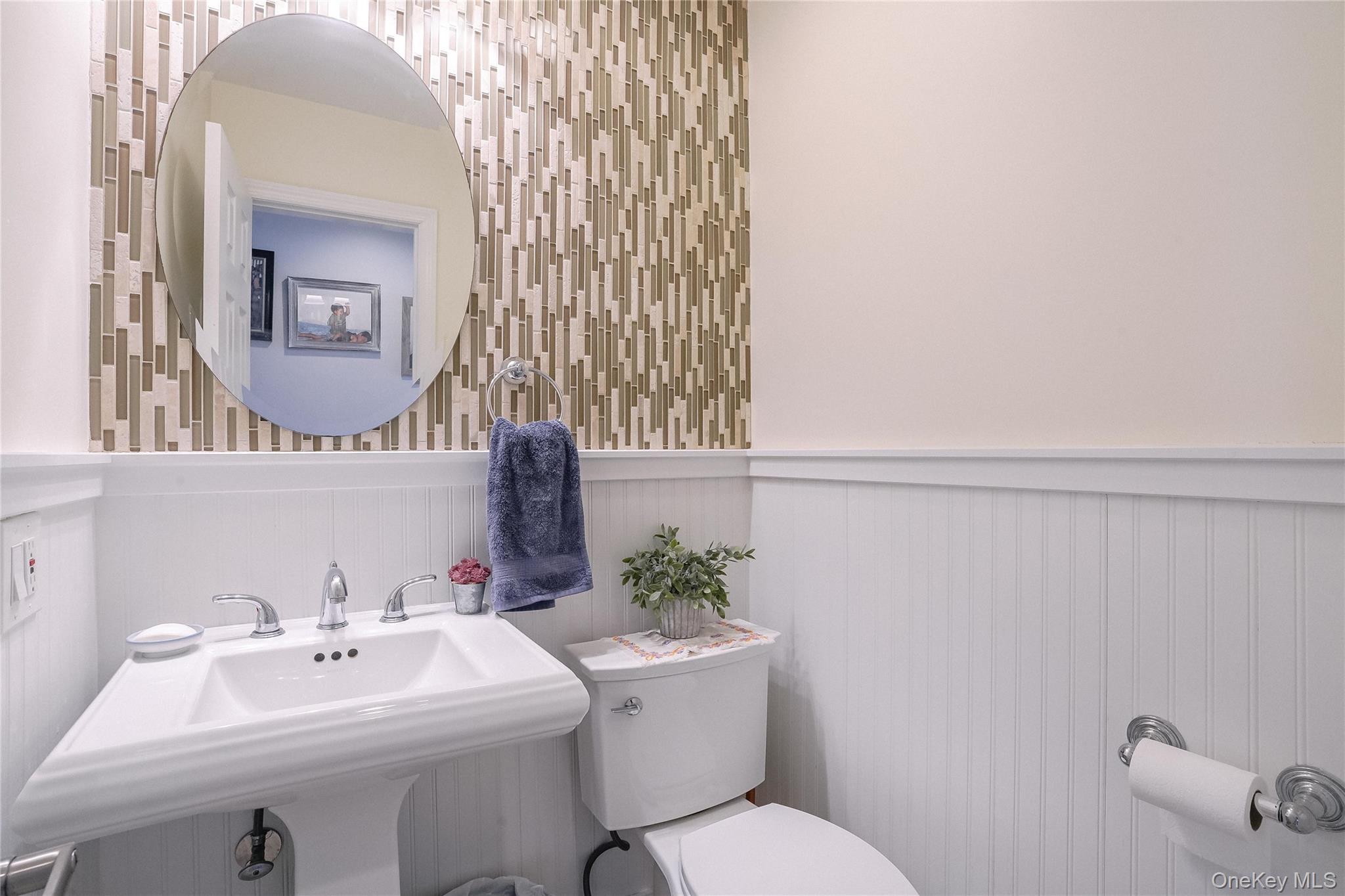 37 Harbor Lane, Unit 2C New Rochelle, NY 10805 - Photo 9 of 17 a bathroom with a sink a toilet and mirror