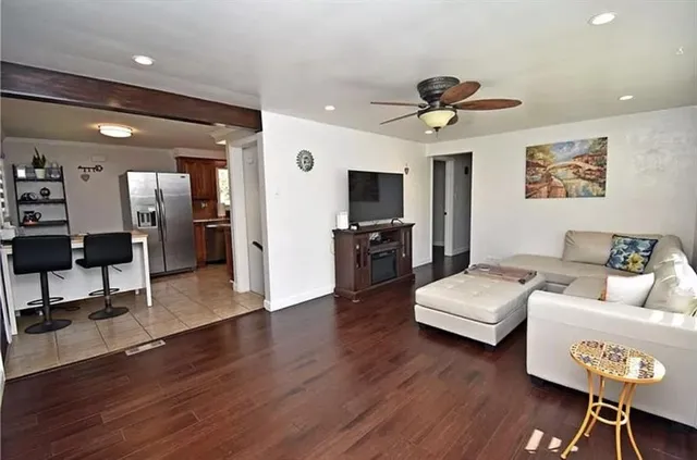 a living room with furniture and a wooden floor